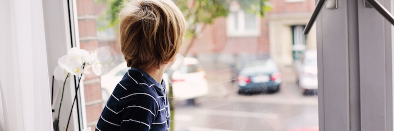 When Advocating Becomes Bullying in the Autism Community young boy looking out window