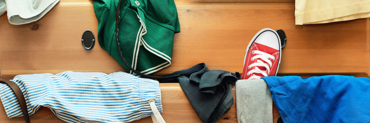 Psychologist's Analogy for Anxiety As Putting Things in Your Closet Clothes and shows coming out of a cluttered dresser