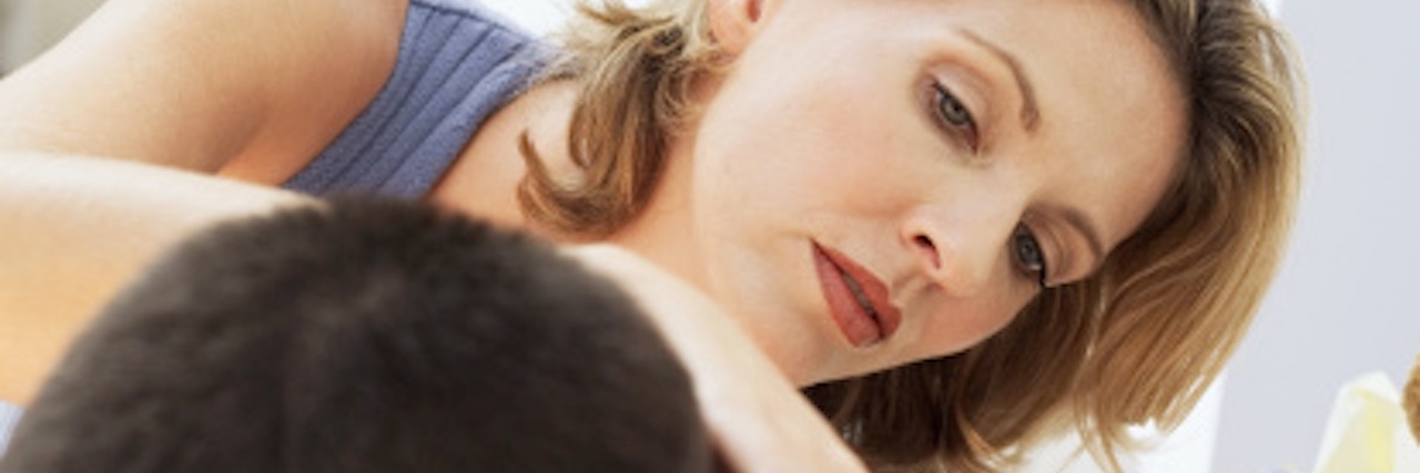 How Parents Can Help Autistic Children Who Self-Injure close-up of a young woman examining the neck of a young boy