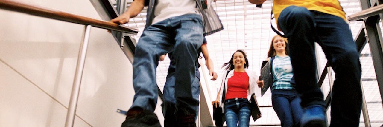 Surviving School as a Student on the Autism Spectrum students running down stairs