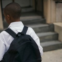Rear view of boy with backpack
