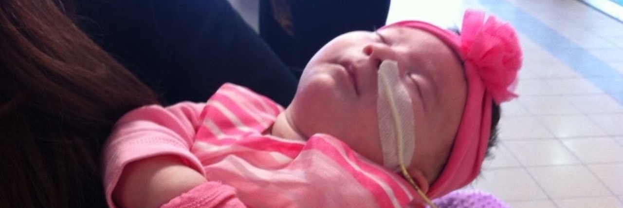 Mother Meets Another Baby With Cri du Chat Syndrome baby girl dressed in hot pink outfit