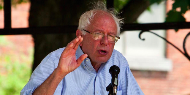 Senator and Presidential candidate Bernie Sanders speaking outside in button down shirt