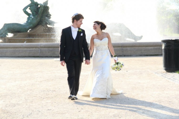 couple on wedding day in front of fountain