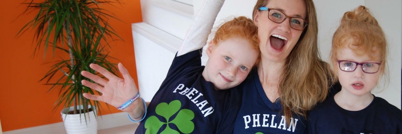 Wearing a T-Shirt to Raise Awareness of Phelan-McDermid Syndrome Victoria with daughters Ashley and Emily