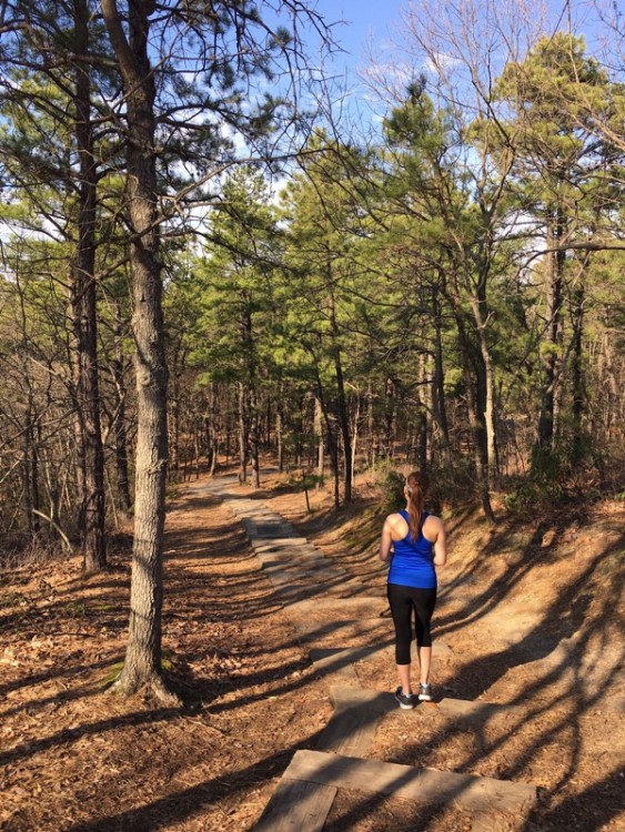 girl walking away down path in woods