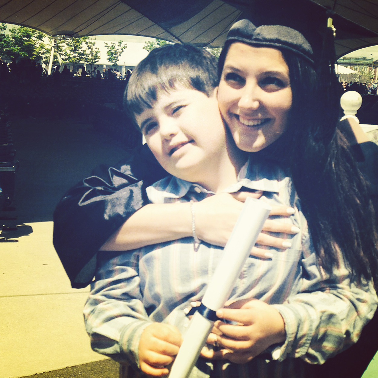 stacey in cap and gown hugging her godson gerry