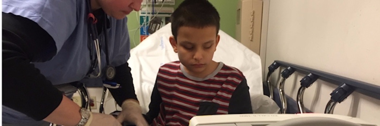 What to Know About Raising a Medically Complex Child boy being treated in hospital bed
