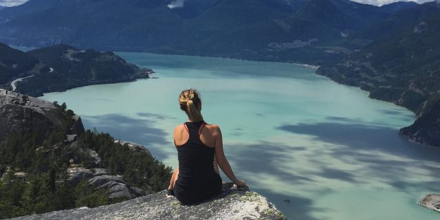 What I Should Have Told the Reporter Who Asked, ‘What Is Arthritis to You?' Woman sitting on rock looking at mountains and lake