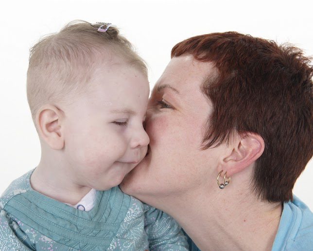mom kissing baby's cheek
