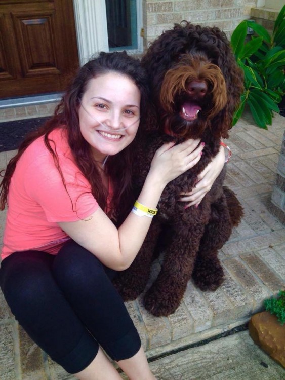 woman hugging brown dog