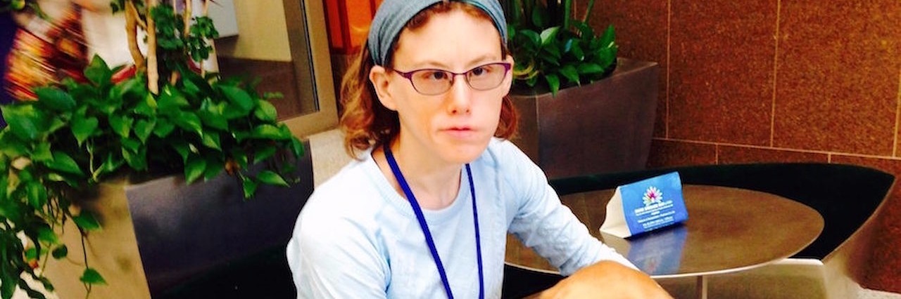 Benefits of Participating in a Research Study for Moebius Syndrome young woman sitting with her service dog