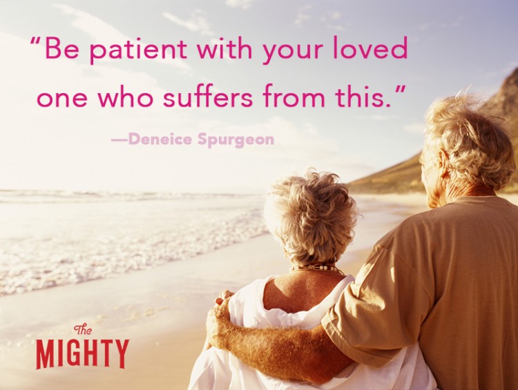 Senior couple embracing on beach, rear view