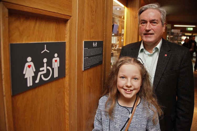 Iain Gray MSP and 10 year old Grace Warnock, a school pupil from Prestonpans in East Lothian, unveil a new disabled toilet signs, designed by Grace, which is now in place at the Scottish Parliament’s accessible toilets.