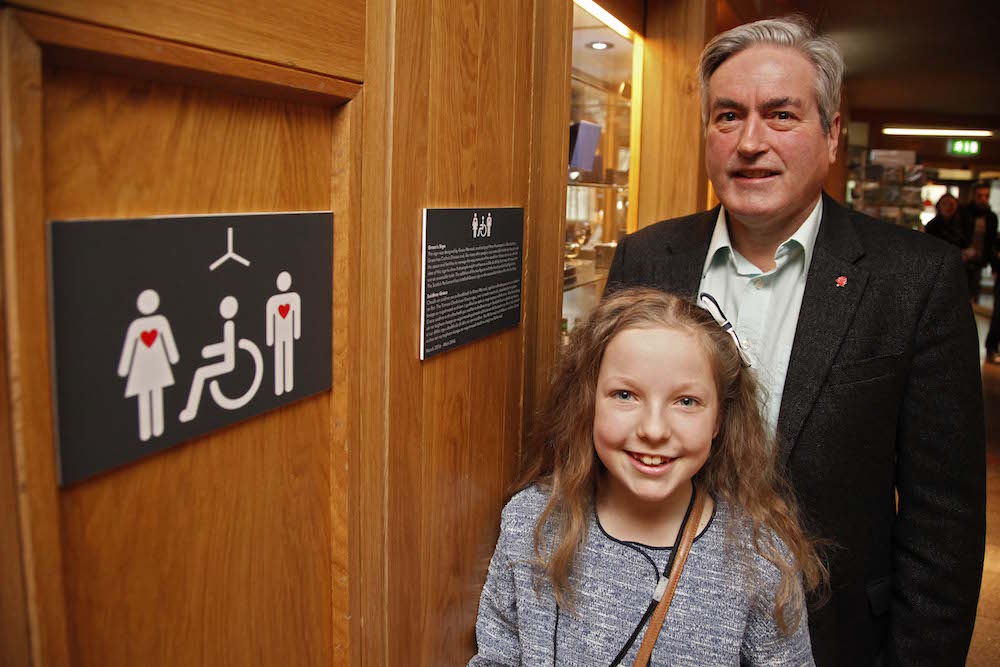 Iain Gray MSP and 10 year old Grace Warnock, a school pupil from Prestonpans in East Lothian, unveil a new disabled toilet signs, designed by Grace, which is now in place at the Scottish Parliament’s accessible toilets. 