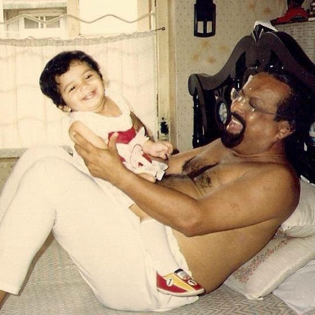 grandfather holding baby granddaughter