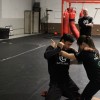 Adaptive self-defense -- two martial arts students grappling