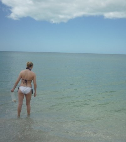 woman standing in ocean looking at horizon