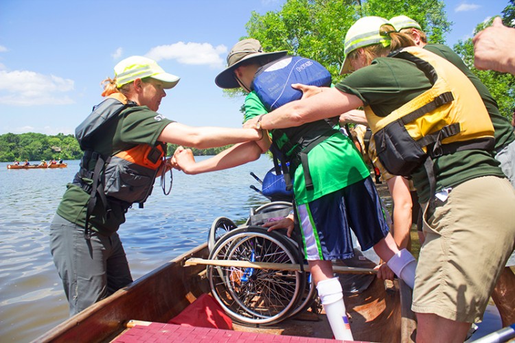 A person with a disability gets into a canoe