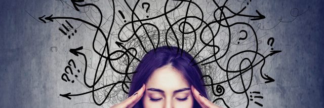 a woman with hands on her temples and drawings of arrows, exclamation points, and question marks spiraling out from her head