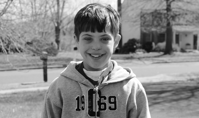 young boy in hoodie in black and white photo