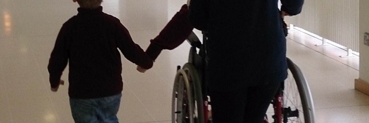 How to Discuss Chronic Illness With Your Friends a picture of child and mother pushing a wheelchair