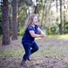 young girl chasing bubbles in the woods