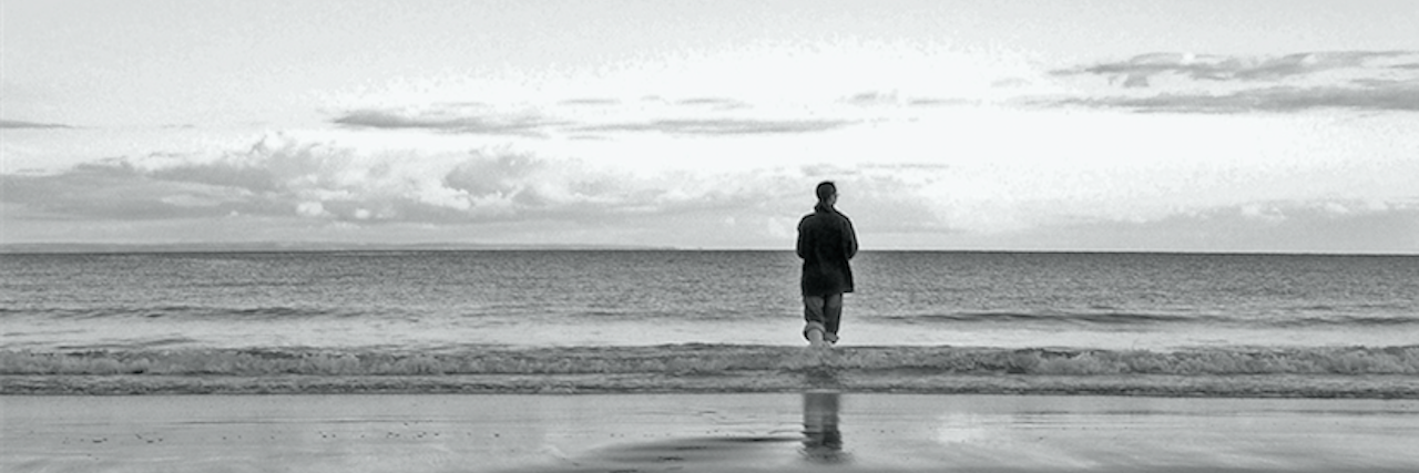 Speaking Up as a Survivor of Suicide Loss lone man standing next to the ocean