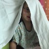 Boy sitting under blanket in the hospital