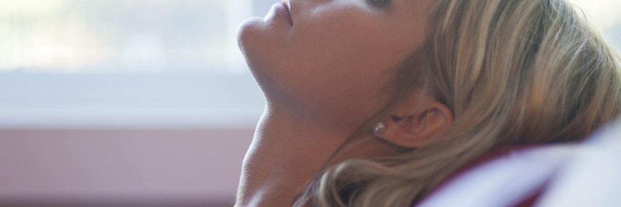 To the Person Who Told Me I Was Depressed woman leaning back on couch