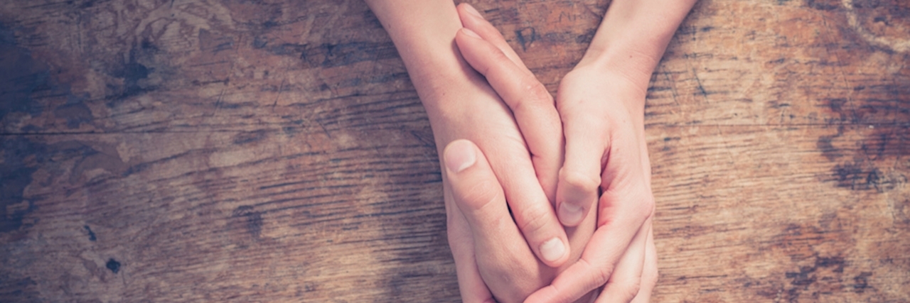 What I Did After Attempting Suicide holding a friend's hand