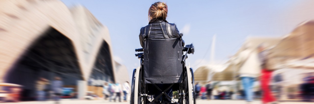young lady in a wheelchair looking for a destination
