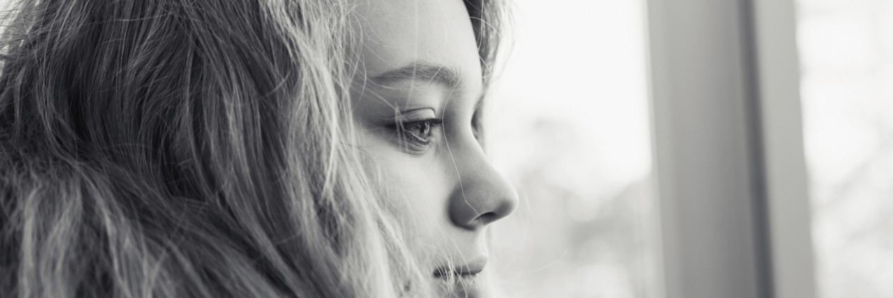Monochrome profile portrait of blond teenage girl