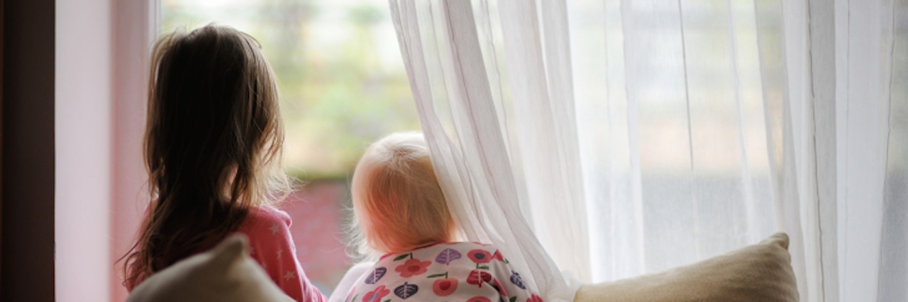 Sibling Writes Letter to Sister With Cri-du-chat Syndrome Two little girls in pajamas looking out of the window