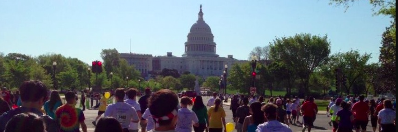 Group of people on organized run heading towards U.S. Capitol building
