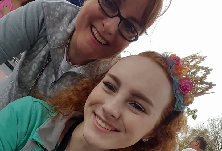 mom with glasses smiling with daughter with red hair