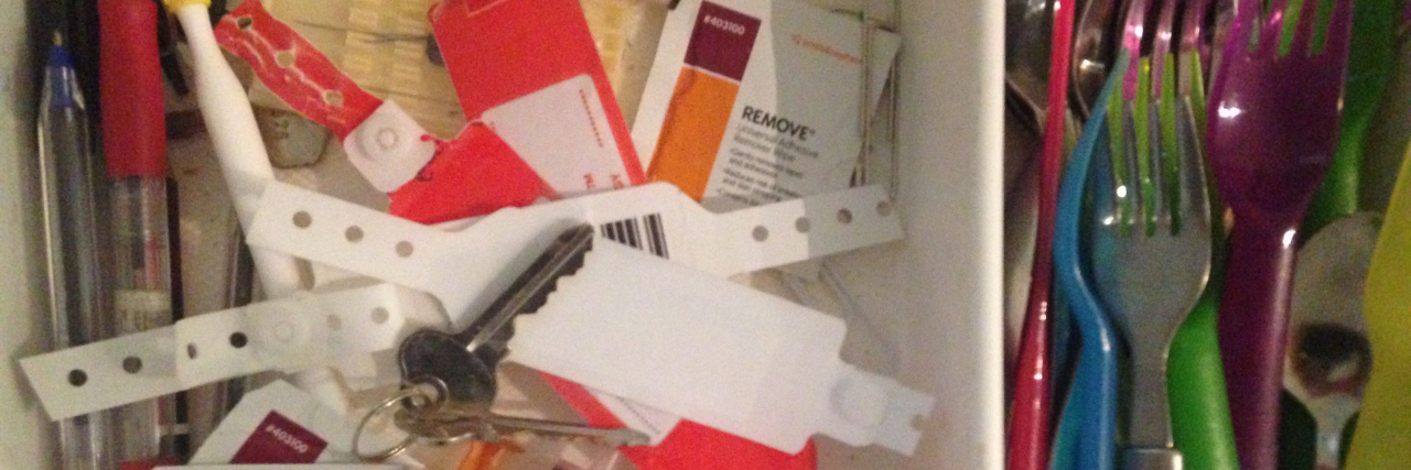 Finding Reminders of Chronic, Invisible Illness and Epilepsy Drawer with hospital bracelets on one side and spoons on the other