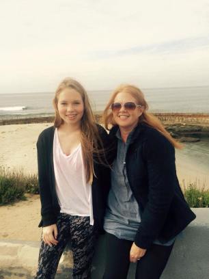 mom and daughter sitting with view of beach