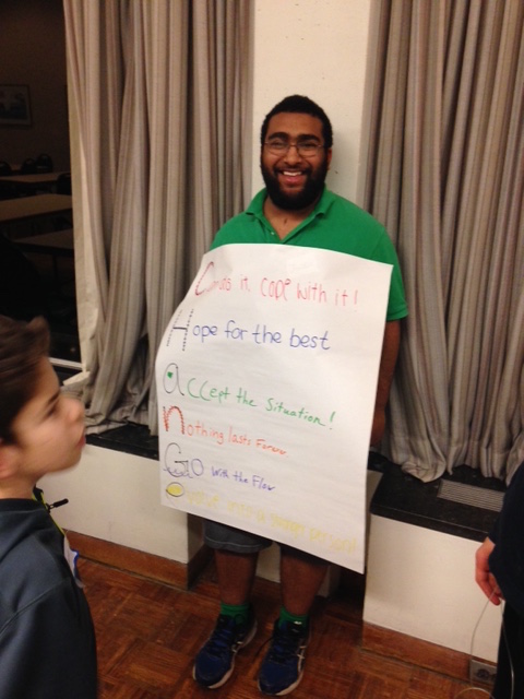 teenage boy showing poster of acrostic poem