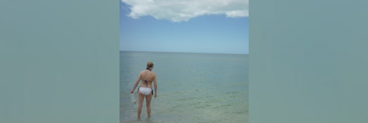 Chronic Disease, Disability and Comparing Yourself to Others Woman standing in shallow water at the beach
