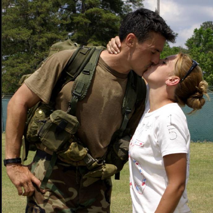 erin kissing her husband in a park