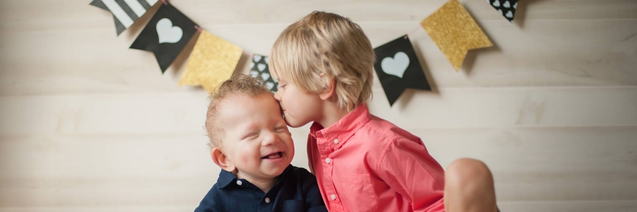 What We Tell Our Healthy Child About Life With His Sick Brother brothers kissing