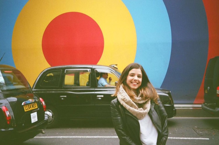 woman standing in front of a car and bullseye sign