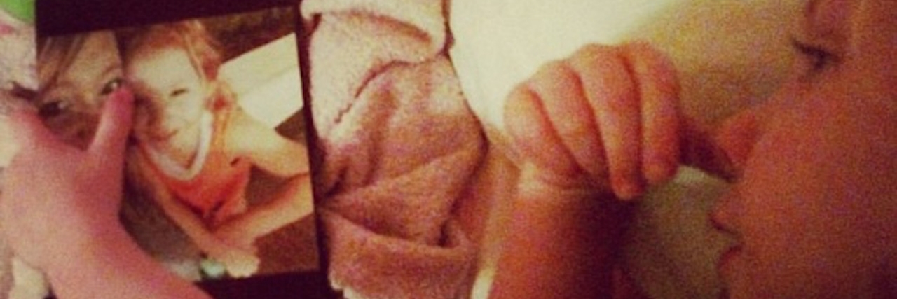 A Child Doesn't Need Words to Say 'I Love You' young girl lying in bed looking at frame photo of her with her mother