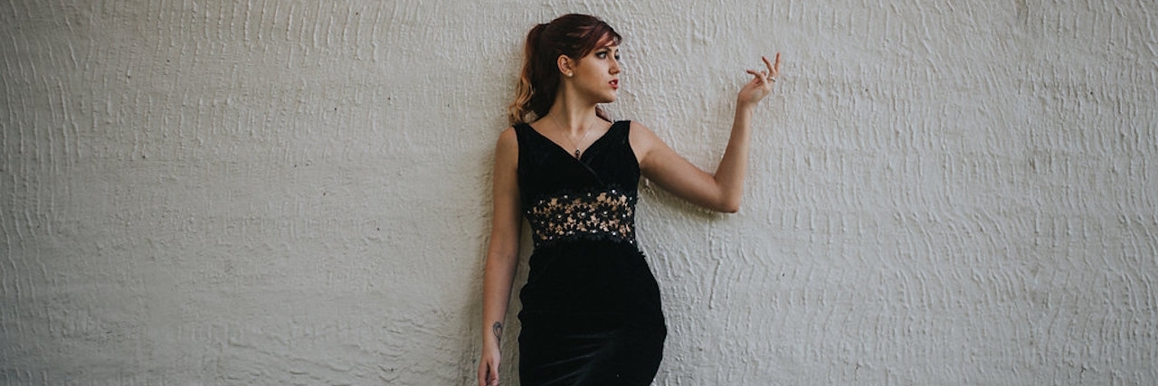 Modeling After Thyroid Cancer: a Photo Shoot Ashley looking down behind a tree branch