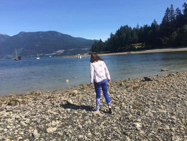 Bailey by a lake wearing her AFO.