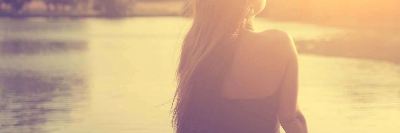 Finding Hope After While Dealing With Chronic Pain woman watching the sunrise