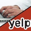 Doctor working on his notebook plus yelp logo