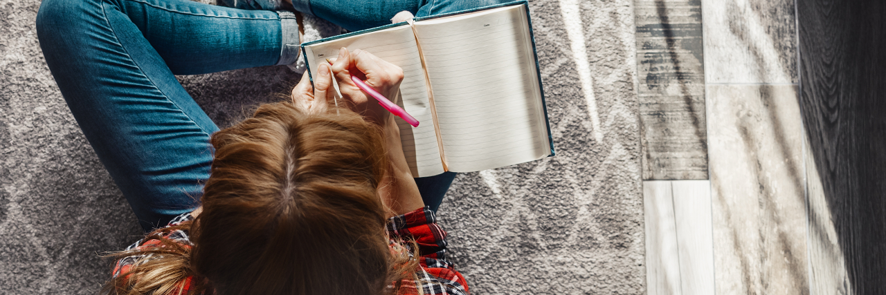 To-Do List for People With Chronic Fatigue Syndrome Young woman sitting on the floor at living room and writing into her diary