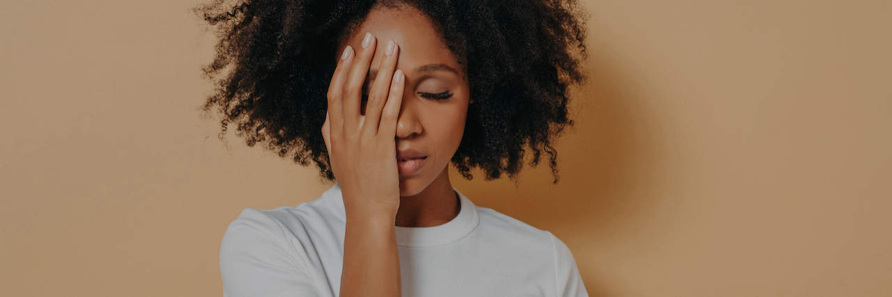 What Not to Say to Someone With Generalized Anxiety Disorder A woman covering her face with her hands